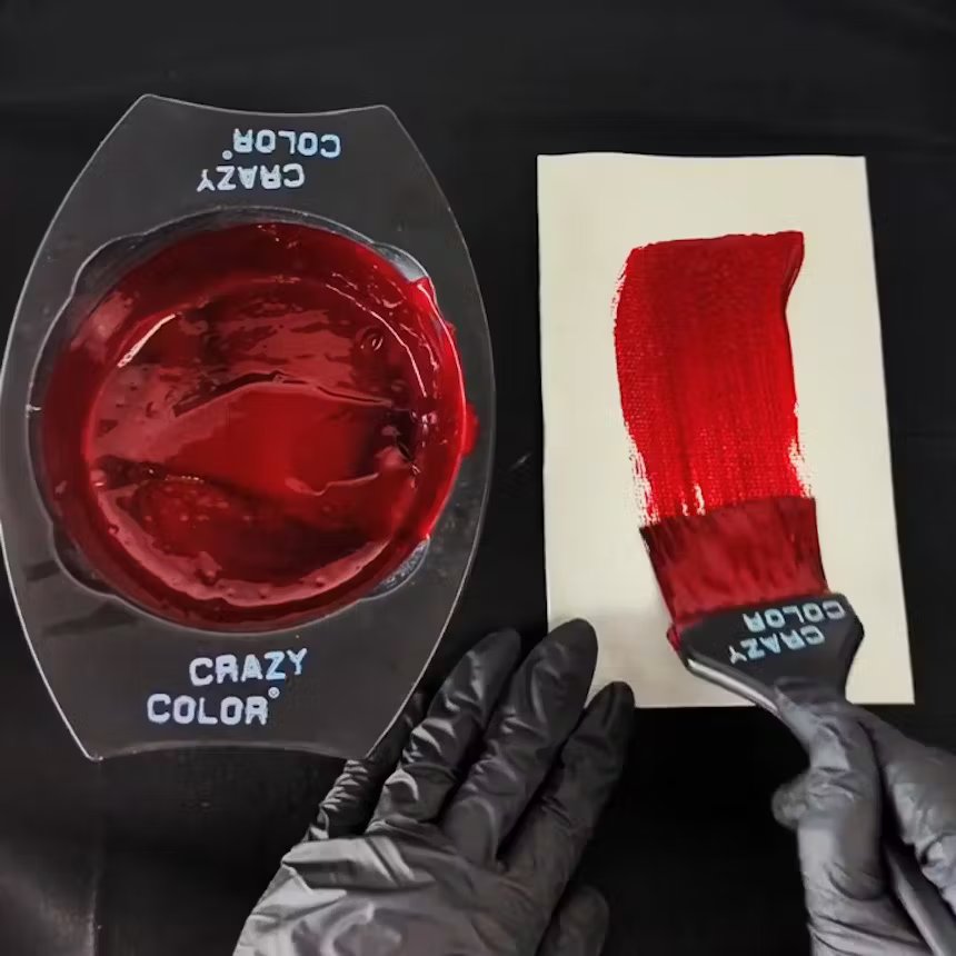 image of woman using crazy color bowl and brush to mix deep red hair dye