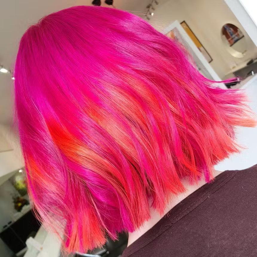 close up of back of woman's cropped hot pink hair