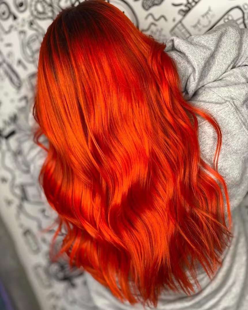 user generated image of close up of the back of a woman's long orange wavy hair