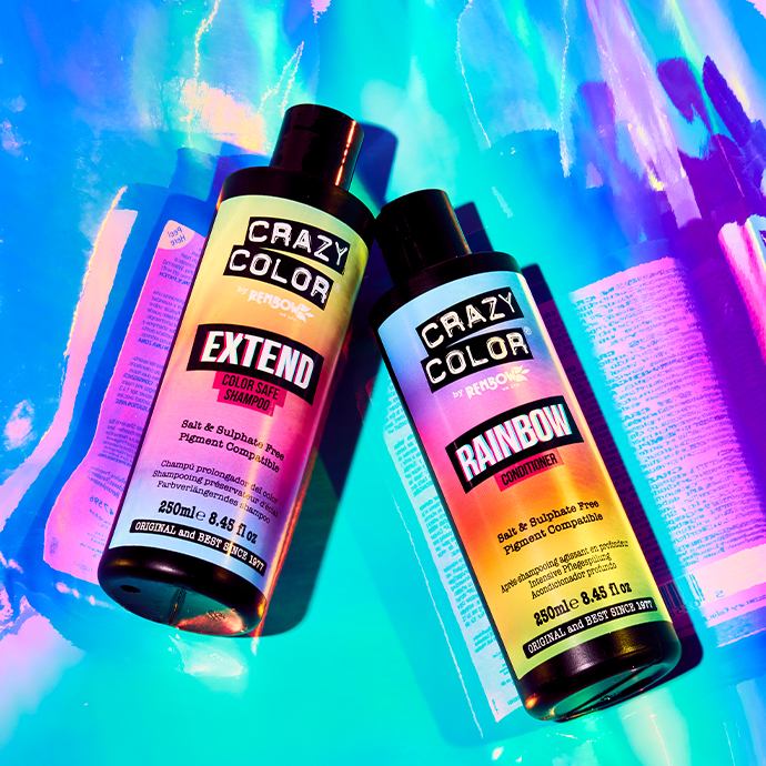 image of Crazy Color extend shampoo and rainbow care conditioner laying on a holographic background 